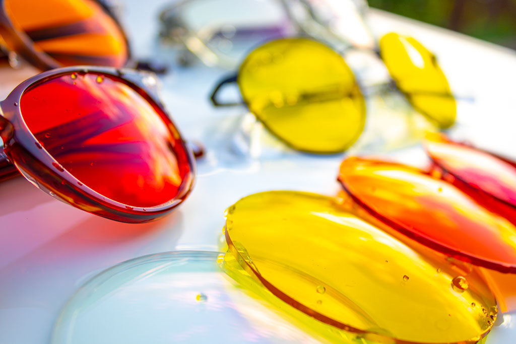 Filter Optix blue light glasses beside Clear, Yellow, Orange and Red lenses.