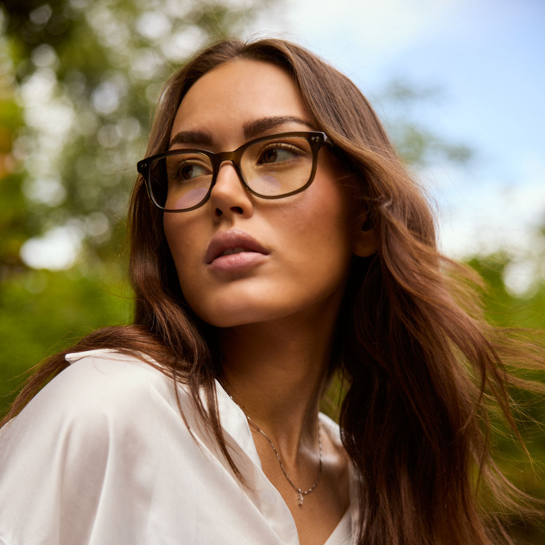 Model is wearing Cedar Olive blue light glasses for better sleep and to reduce stress