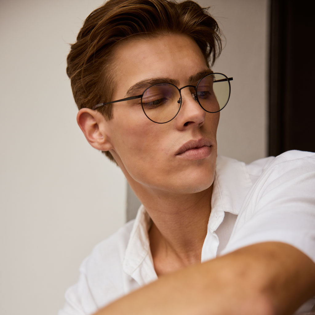 Model is wearing Mesi Matte Black computer glasses with premium quality and eco-friendly materials